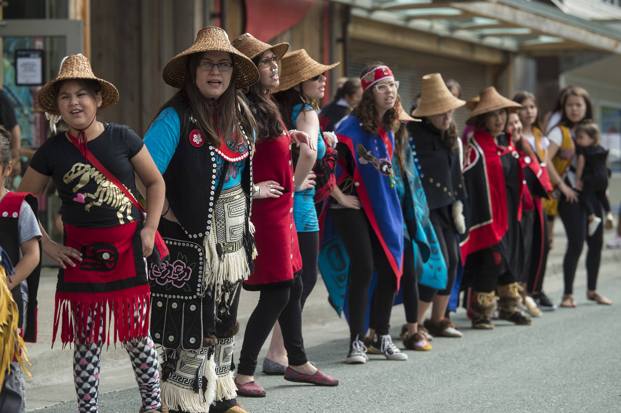 Members of the Woosh ji .een Dance Group perform during an unveiling ceremony for three bronze house posts in front of the Walter Soboleff Center by Sealaska Heritage Institute on Sunday, Aug. 26, 2018. (Michael Penn | Juneau Empire)