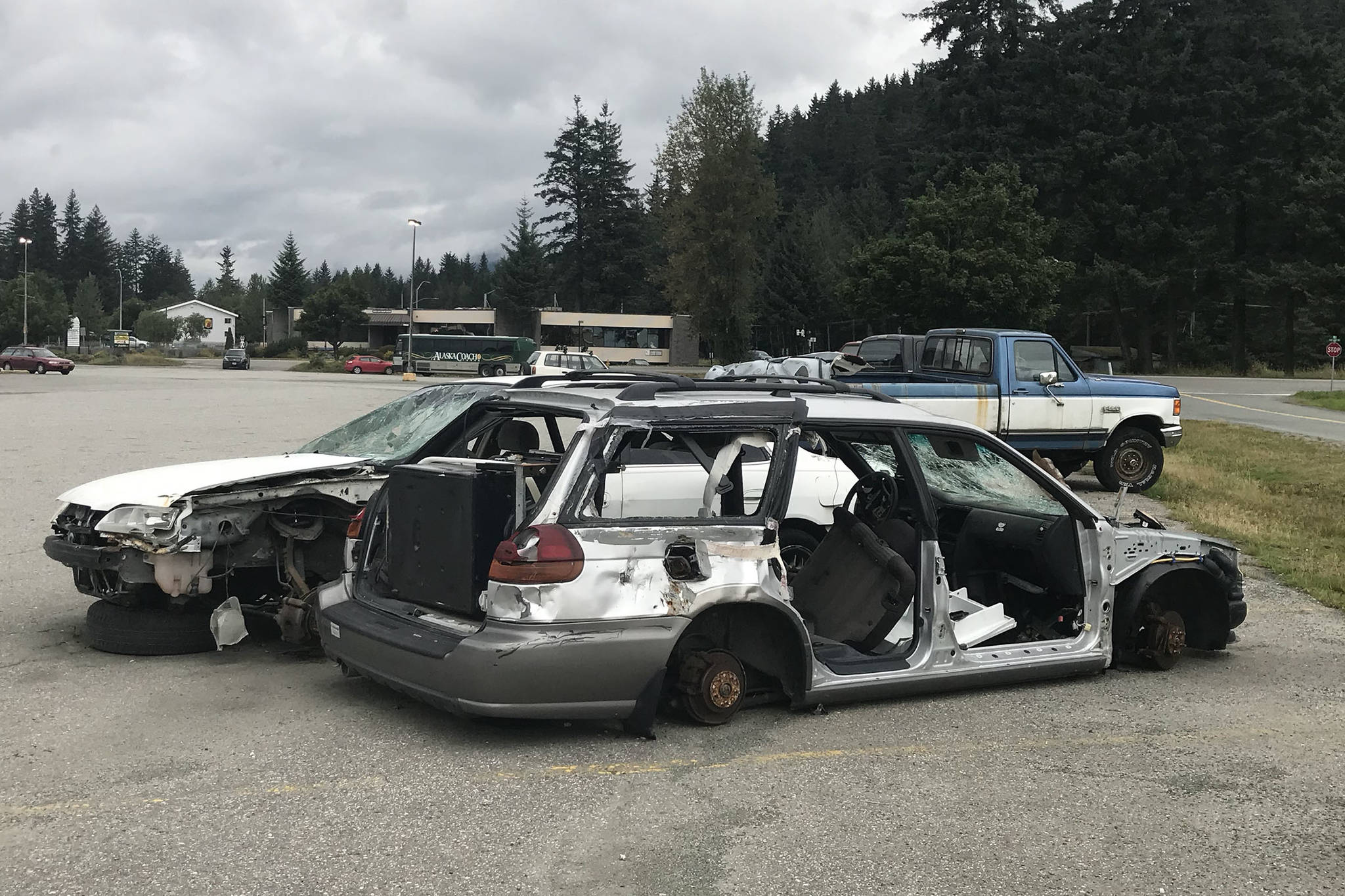 Abandoned cars sit in the parking lot of the Nugget Mall on Thursday, Aug. 30, 2018. The Juneau Police Department is evaluating approaches to getting abandoned vehicles off private property faster. (Alex McCarthy | Juneau Empire)