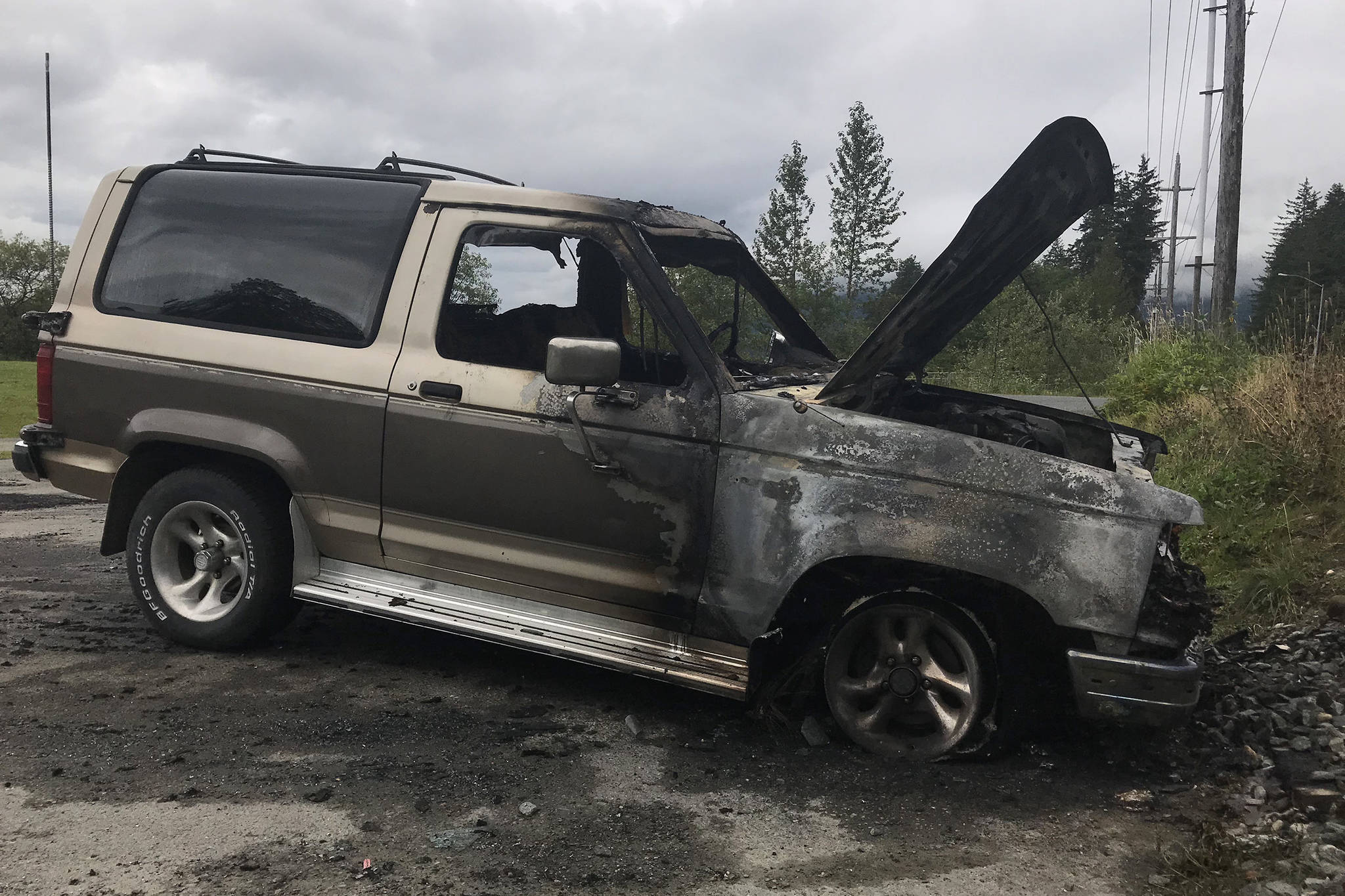 A burnt 1990 Ford Bronco 2 sits in a parking lot near Twin Lakes on Thursday, Aug. 30, 2018. The fire started when the front right brake caliper got stuck and overheated, Capital City Fire/Rescue Assistant Chief Ed Quinto said. (Alex McCarthy | Juneau Empire)