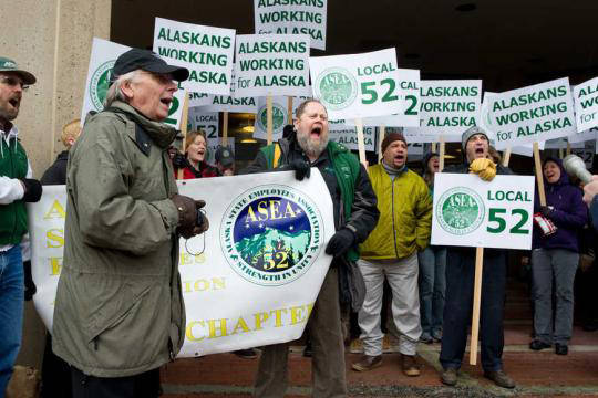 Alaska State Employees Association Business Manager Jim Duncan leads union members in a chant during a rally at the State Office Building in 2013. (Michael Penn | Juneau Empire file)