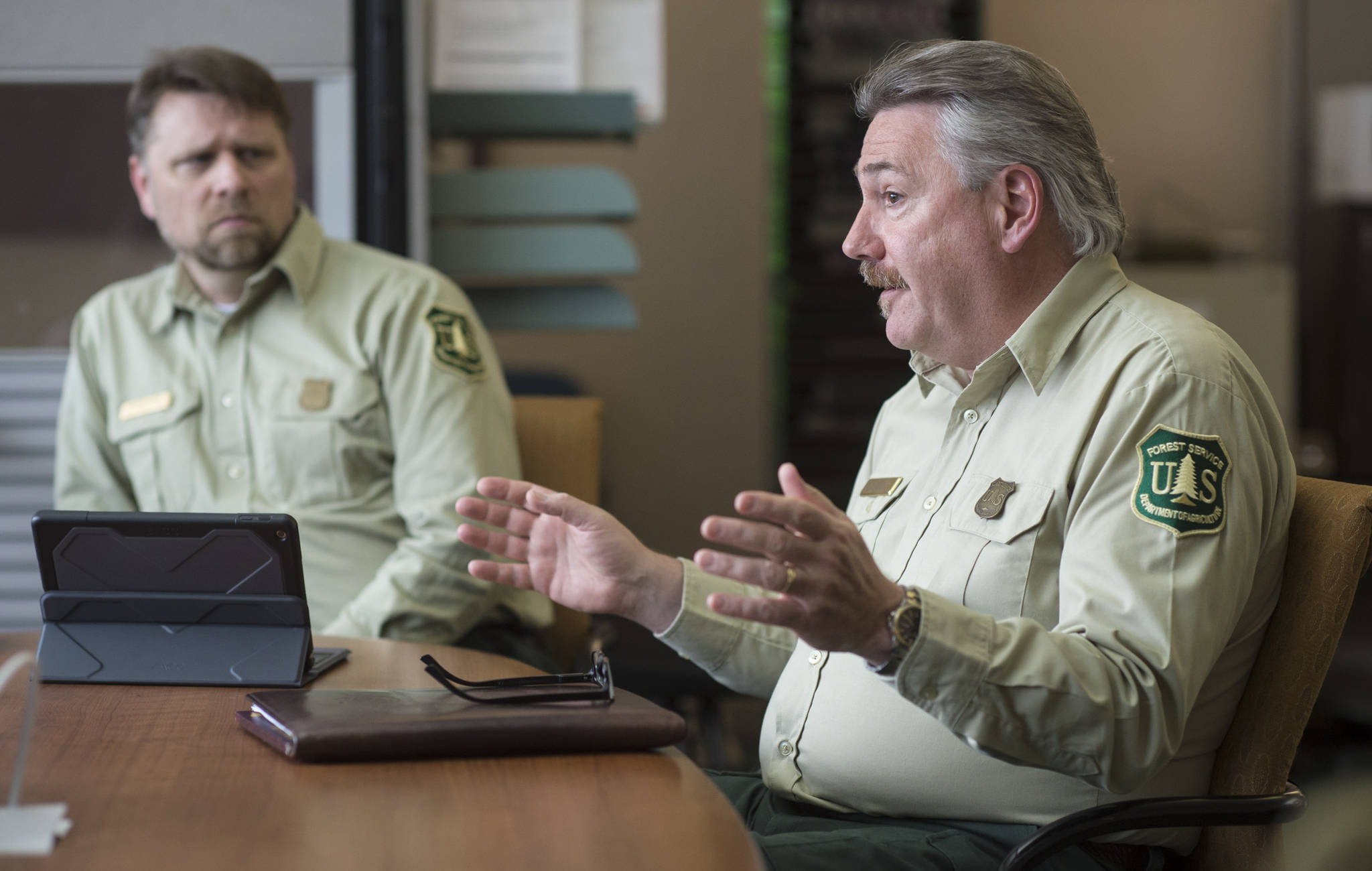 Acting Regional Forester Dave Schmid, right, and Associate Deputy Chief of National Forest System Chris French talk Thursday, August 2, 2018, about an agreement about how the roadless rule will affect Alaska national forests. (Michael Penn | Juneau Empire)