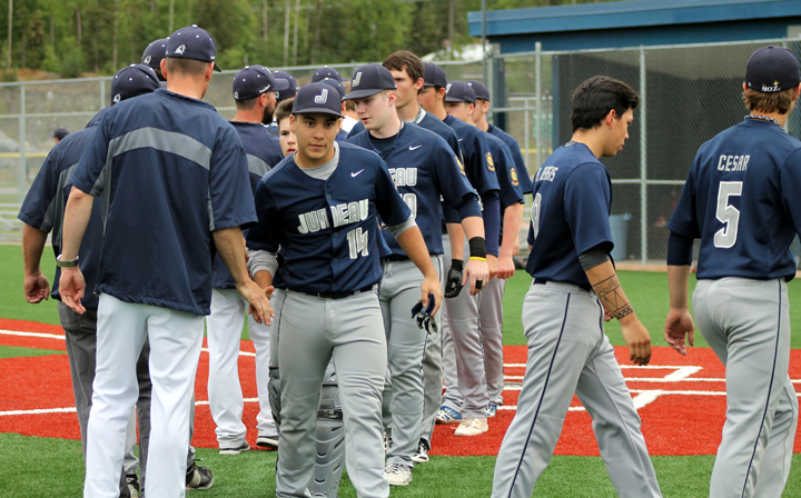 Juneau players shake hands with Eagle River, after winning 14-0 on Sunday, June 26, at the Lorretta French Sports Complex in Chugiak.