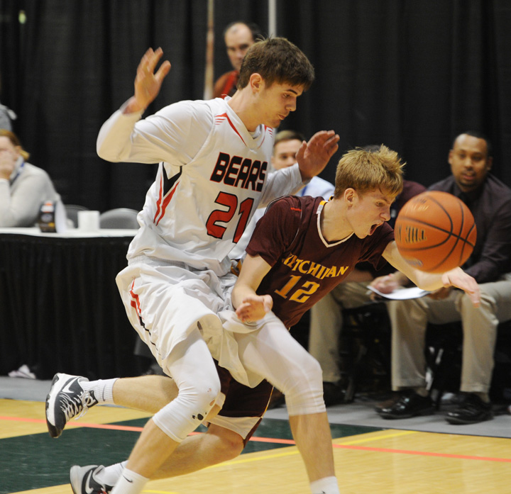 JDHS' Bryce Swafford (21) and Ketchikan’s Matt Standley collide in the game’s waning moments.