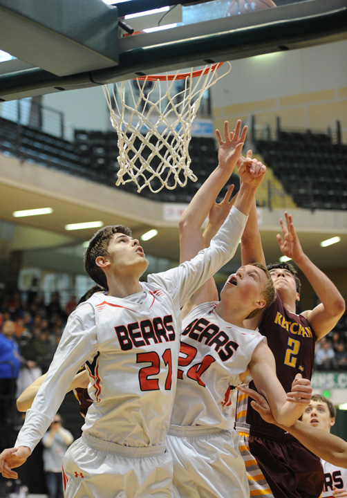 JDHS' Bryce Swofford and Erik Kelly (24) battle for a rebound with Ketchikan’s Isaac Johnson.