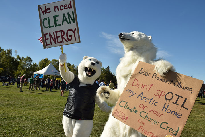 Julia Bevins, left, of Anchorage and Steve Jones of San Francisco wear polar bear costumes during a climate action rally on the Park Strip in Anchorage during President Obama's 2015 visit to the city. Alaska appears to be changing course on climate change, according to the Speaker of the House and one of the state's most prominent conservation scientists.