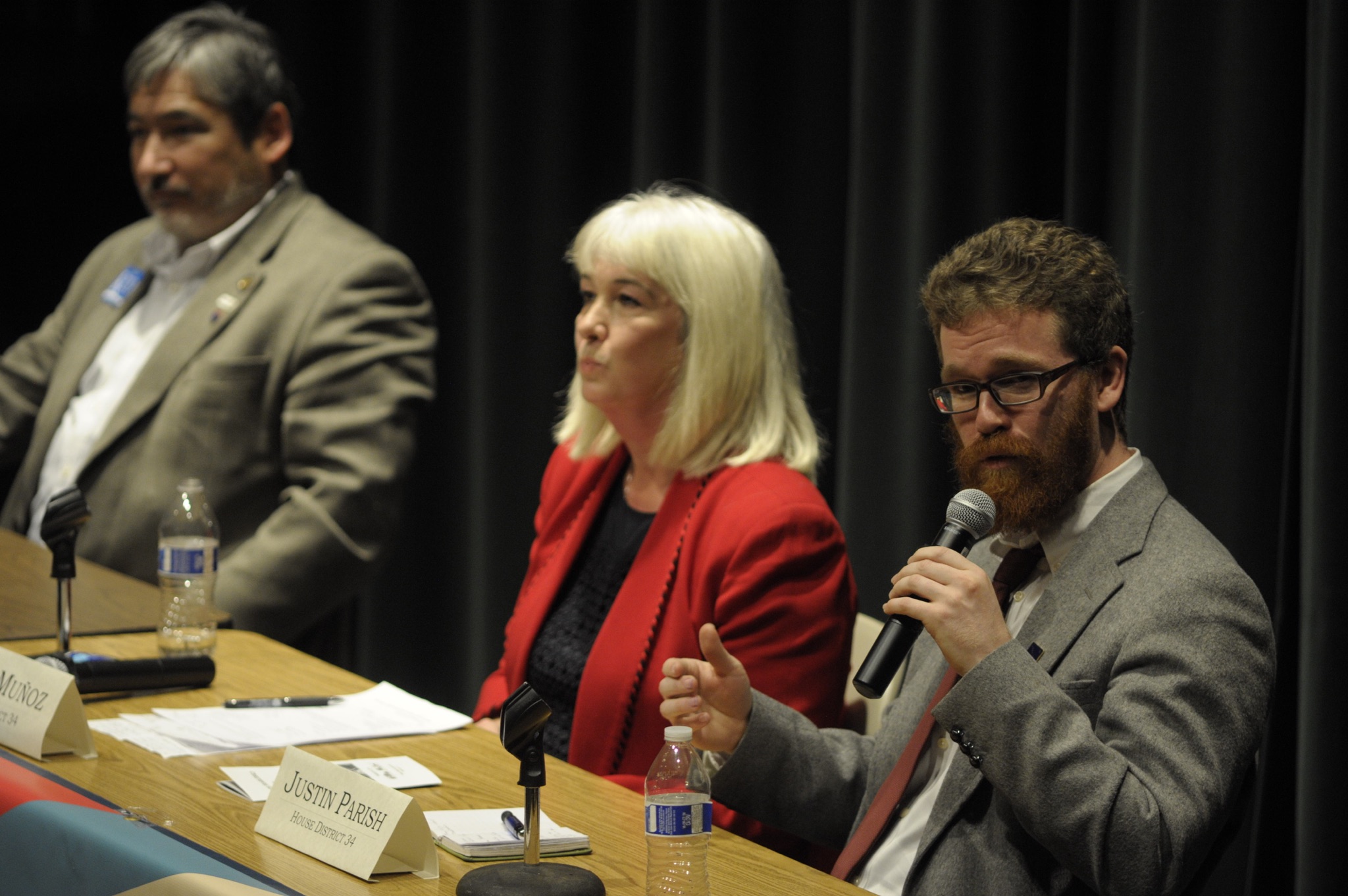 Democrat Justin Parish, candidate for House District 34, speaks during Thursday night's Juneau votes forum at the University of Alaska Southeast. At left, his opponent, incumbent Rep. Cathy Muñoz, R-Juneau, waits to rebut his comments. At far left is Rep. Sam Kito III, D-Juneau, who is unopposed for re-election to House District 33.