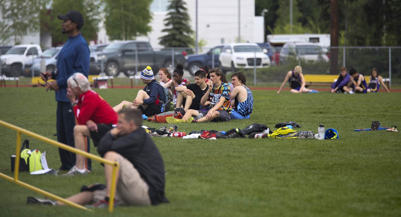 Athletes, coaches and volunteers anxiously watch paramedics attend to Monroe freshman Joseph Balko during the Region VI Track and Field Championships at West Valley on Friday. Balko collapsed upon finishing the Class 3A 3,200-meter run Friday and passed away Saturday at Providence Hospital in Anchorage.