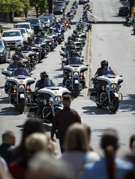 In this Thursday, May 5 photo, a motorcade of motorcycles, led by the Illinois State Police, make their way down Capitol Avenue during the 31st annual Police Officer Memorial Day at the State Capitol in Springfield, Ill.