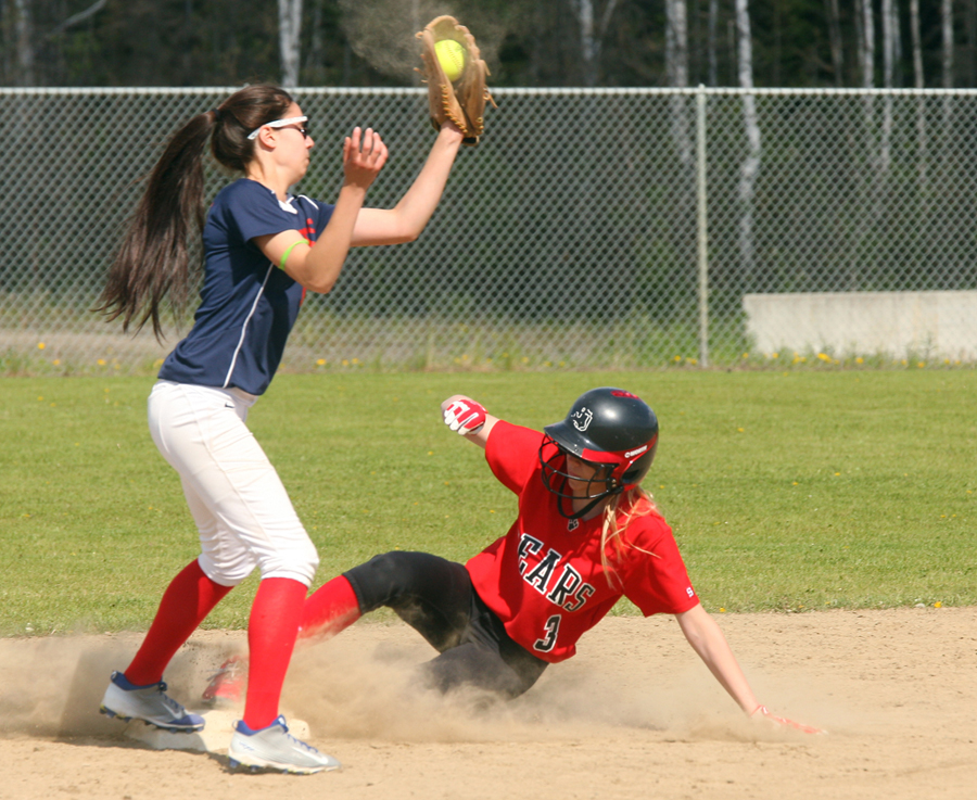 Juneau-Douglas High School's Sami Good slides into third base as North Pole's Carley Donald tries to make the play during the State High School Softball Championship Tournament small schools game Friday. JDHS won that game, and defeated North Pole again Saturday to stage a showdown against crosstown rival Thunder Mountain in the championship game.