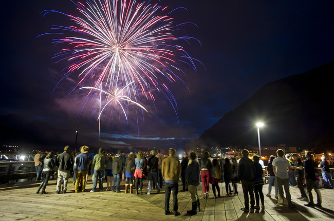 In this file photo from last month, people watch as the city's annual Fourth of July fireworks display takes place downtown.