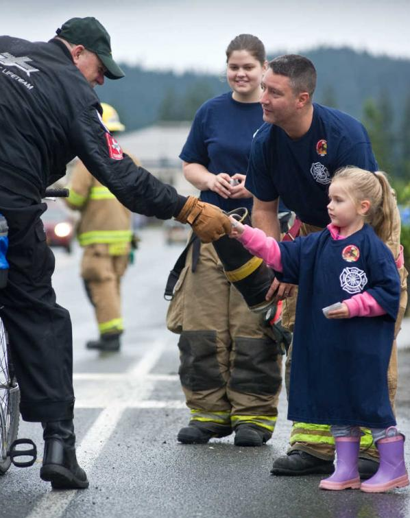 In this file photo from September 2013, Raegan Adams, 4, gives John Adams, left, a Muscular Dystrophy Association sticker for his contribution to the "Fill the Boot" fundraiser put on by members of Capital City Fire/Rescue in front of the Mendenhall Mall.