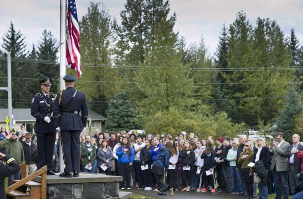 In this file photo from Sept. 11, 2015, audience members watch as the national flag is raised during the 9/11 Memorial Ceremony at Rotary Park on Riverside Drive.