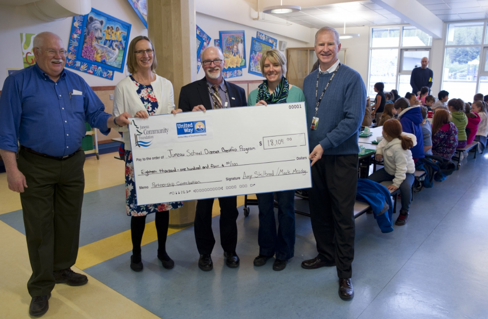 In this file photo from May 2016, Wayne Stevens, President/CEO of the United Way of Southeast Alaska, left, and Amy Skilbred, Executive Director of the Juneau Community Foundation, second from left, present a check for $18,104 on Wednesday, May 18, to help fund the Juneau School District's Elementary School Breakfast Program next year. Receiving the check are JSD Superintendent Dr. Mark Miller, center, Glacier Valley Elementary Principal Lucy Potter and Brian Holst, President of Juneau School Board.