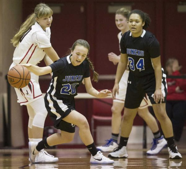 In this file photo from Dec. 27, Thunder Mountain's Izzy Luna steals the ball from Juneau-Douglas' Caitlin Pusich during the Capital City Classic at JDHS.