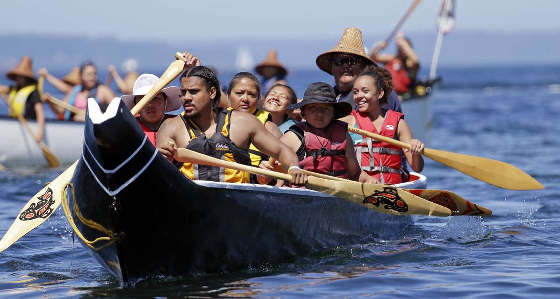 Pullers from the Puyallup Tribe head toward a landing during an annual canoe journey Wednesday in Seattle. Dozens of tribal canoes were arriving at Alki Beach in Seattle as part of an annual Native American celebration. Members of the Muckleshoot Tribe greeted the boats Wednesday afternoon as part of the 2016 Paddle to Nisqually.