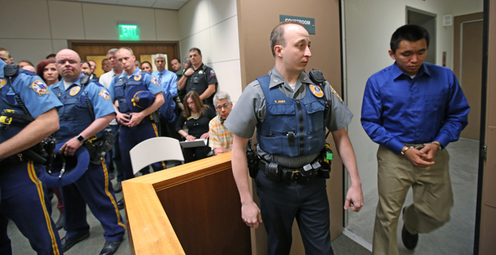 Nathanial Kangas, right, is escorted into Superior Court Judge Paul Lyle's courtroom at the Rabinowitz Courthouse on Monday afternoon, May 16 in Fairbanks. A Fairbanks jury deliberated six hours before convicting Kangas, 22, in the deaths of Sgt. Scott Johnson and Trooper Gabe Rich in May 2014, the Fairbanks Daily News-Miner reported. The officers were shot at Kangas' home in the village of Tanana, about 130 miles west of Fairbanks, as they attempted to arrest Kangas' father.