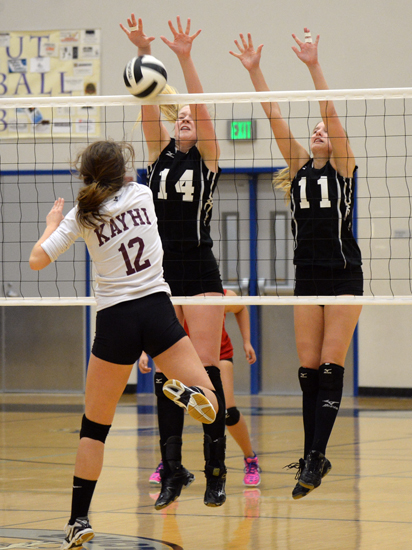Juneau-Douglas' Maddie McKeown (14) and Kallen Hoover (11) block a spike by Ketchikan's Gabby Clark (12) during Friday's 4A Region V volleyball tournament action at Thunder Mountain High School.