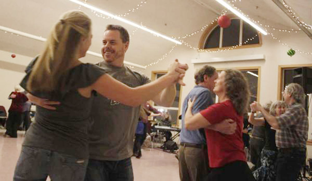 Dancers spin their partners during the New Year's Eve Barn Dance Dec. 31, 2014 at St. Ann's Parish Hall.