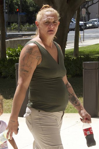 In this May 22, 2015 file photo, Samantha Leialoha Watanabe walks outside of federal court in Honolulu. On Tuesday, Dec. 8, 2015, a federal jury found her guilty of assaulting her 15-month-old daughter on a flight from Alaska in May. Prosecutors say Watanabe cursed at her daughter, smacked her in the head, hit her in the face with a stuffed doll and yanked out tufts of her hair. They say passengers and flight attendants on the May 3 Alaska Airlines flight believed Watanabe was unnecessarily rough to a generally well-behaved toddler.