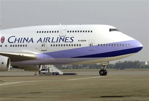 In this Jan. 26, 2003, file photo, a China Airlines Boeing 747-400 sits on the tarmac at the Chiang Kai-shek International airport in Taoyuan, Taiwan. A woman deported to her homeland Taiwan after giving birth on a China Airlines flight on Oct. 8, 2015, to the U.S. in an apparent attempt to give her baby American citizenship may have to pay hefty compensation for forcing the plane to divert.