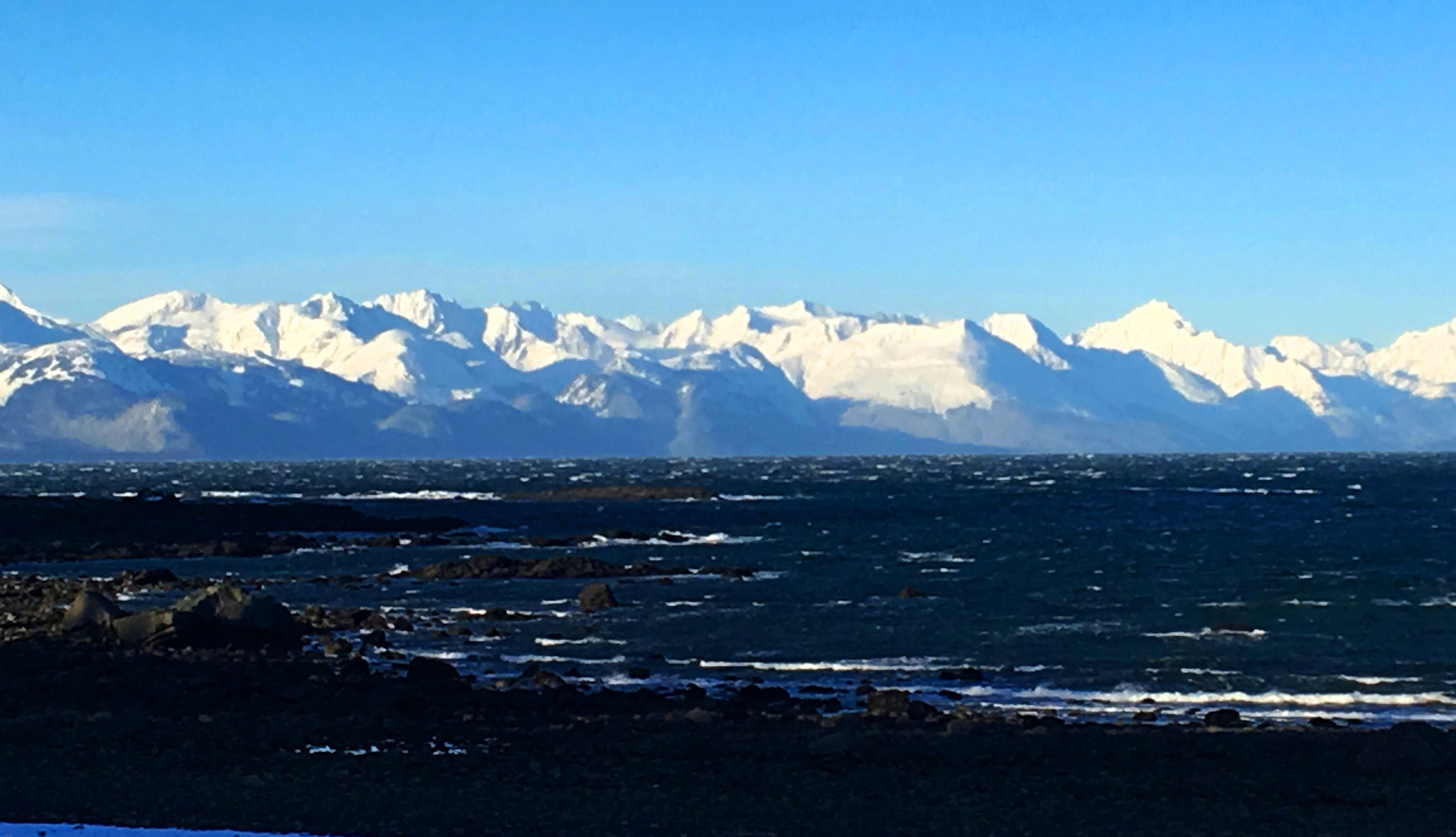 Pounding surf with the serene Chilkats in the background on Jan. 20. (Denise Carroll)