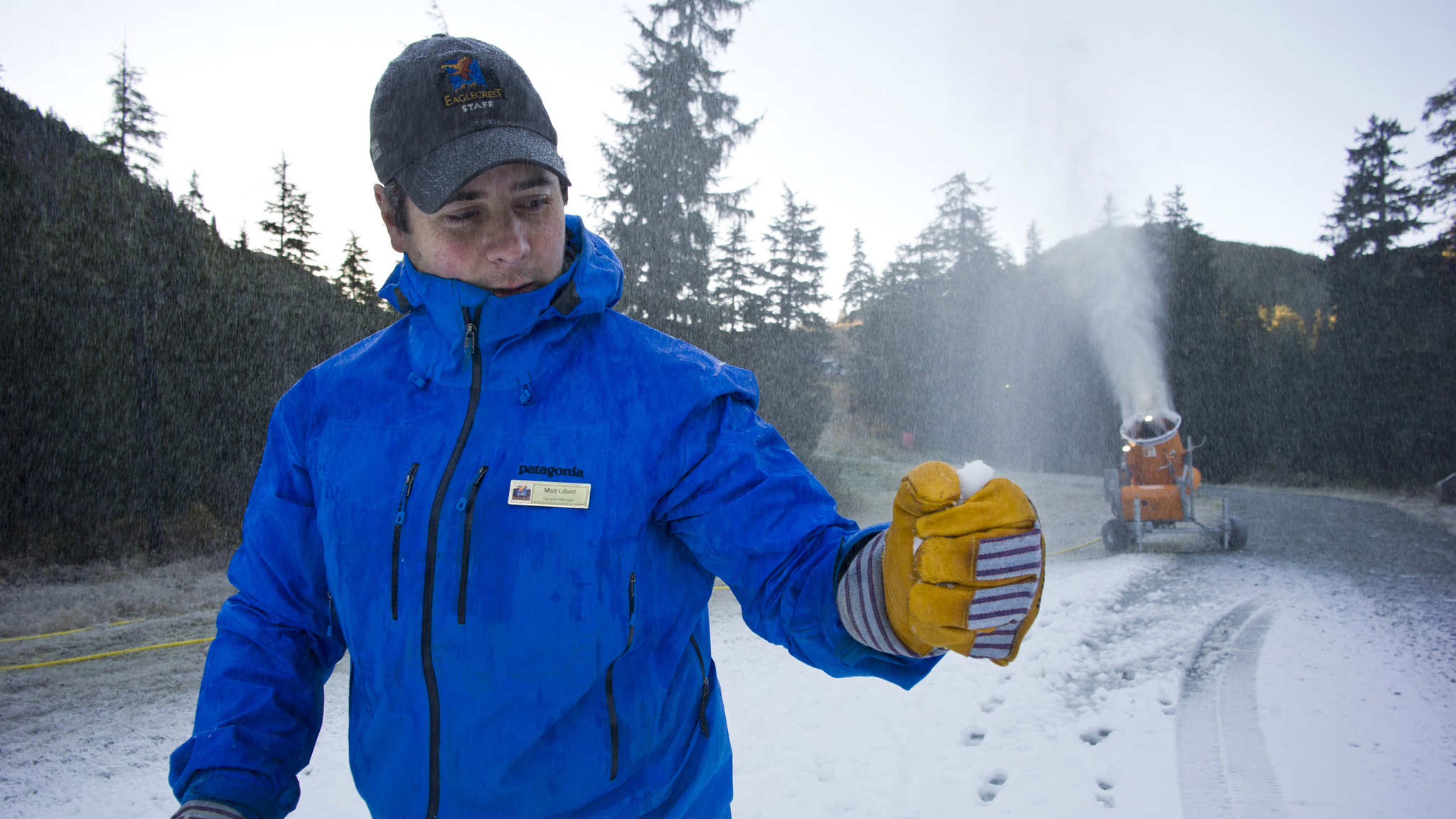 Eaglecrest General Manager Matt Lillard checks the quality of the snow while running a snow making machine for the first time this season on Oct. 11, 2016. (Michael Penn | Juneau Empire File)