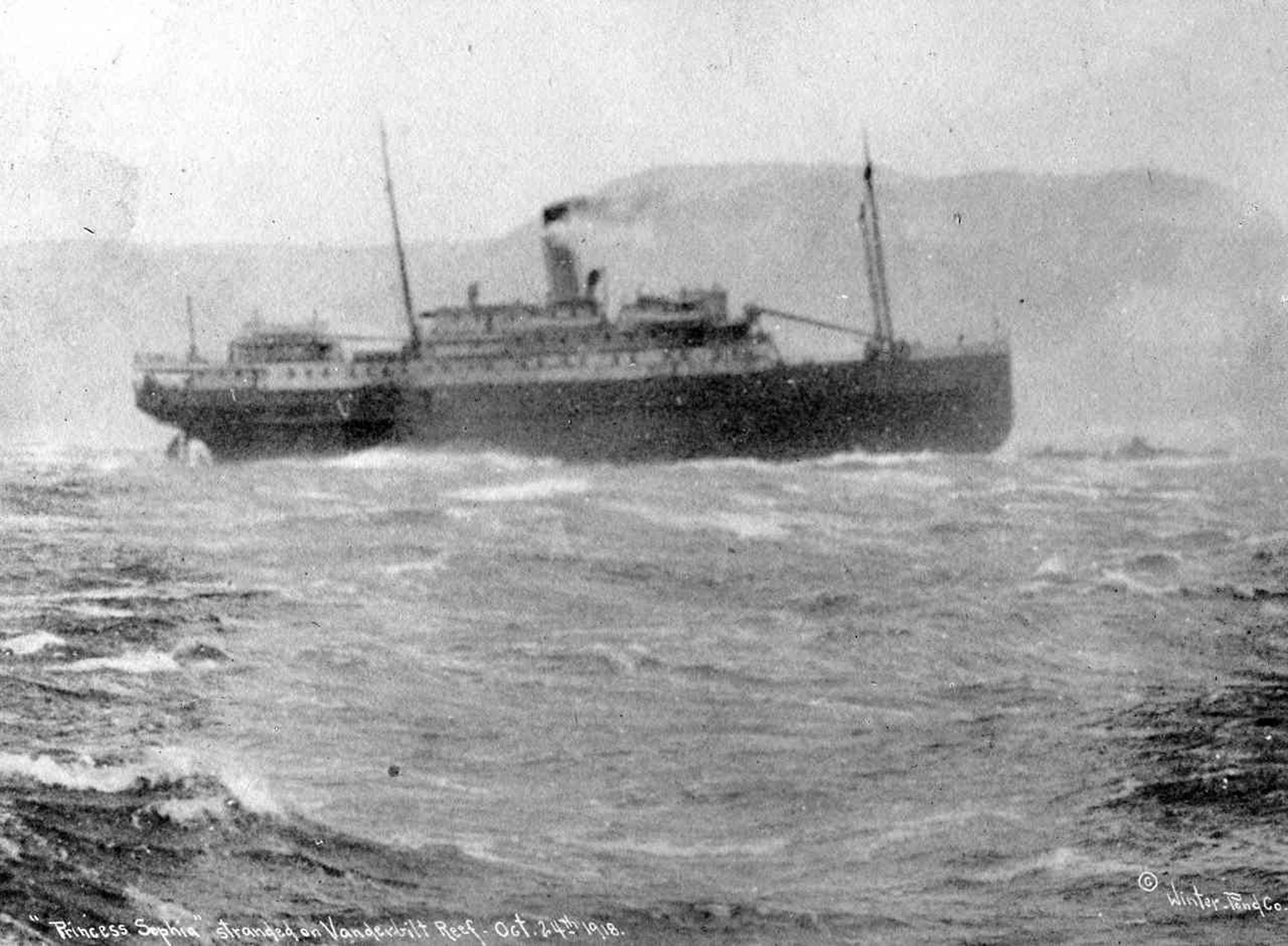 The SS Princess Sophia perched precariously on Vanderbilt Reef as the storm raged. (Courtesy Photo | Winter & Pond photo, Alaska Historical Library)