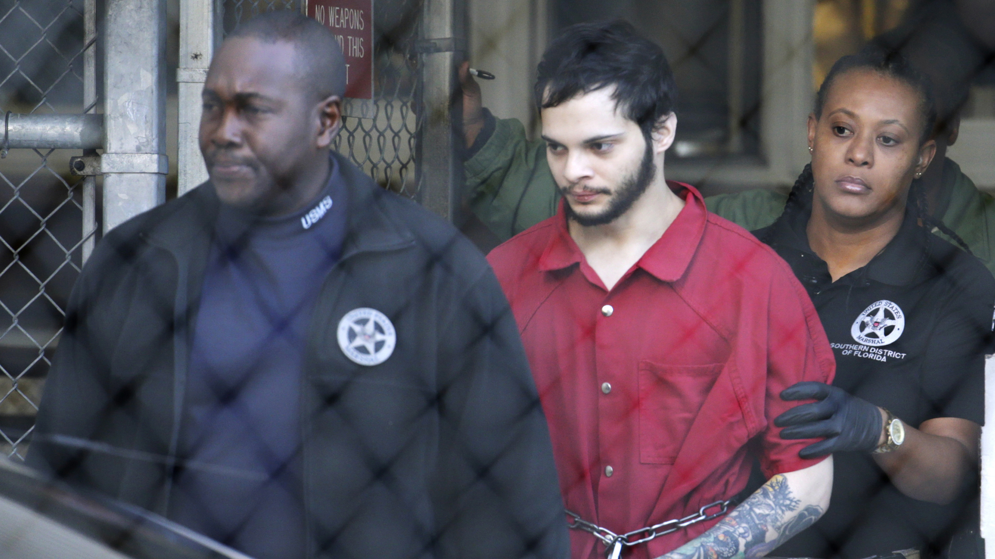 Esteban Santiago, center, is led from the Broward County jail for an arraignment in federal court, Monday, Jan. 30, 2017, in Fort Lauderdale, Fla. Santiago is charged in a 22-count federal indictment in the Jan. 6 shooting at the Fort Lauderdale-Hollywood International Airport. (Lynne Sladky | The Associated Press)