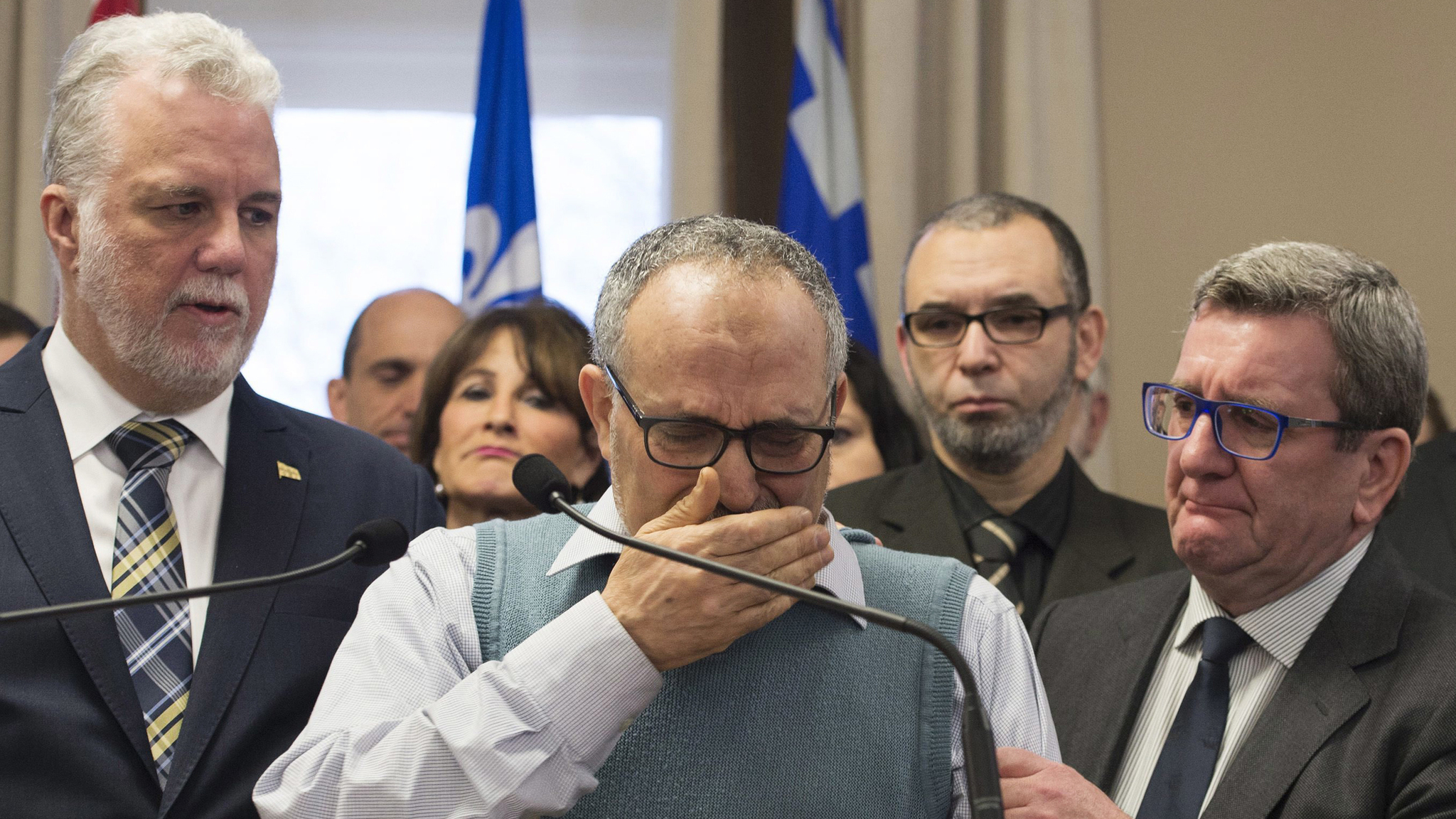 Mohamed Labidi, the vice-president of the mosque where an attack happened, is comforted by Quebec Premier Philippe Couillard, left, and Quebec City mayor Regis Labeaume, right, during a news conference Monday, Jan. 30, 2017, about the fatal shooting at the Quebec Islamic Cultural Centre on Sunday. Prime Minister Justin Trudeau and Couillard both characterized the attack at the mosque during evening prayers as a terrorist act. Jacques Boissinot | The Canadian Press)