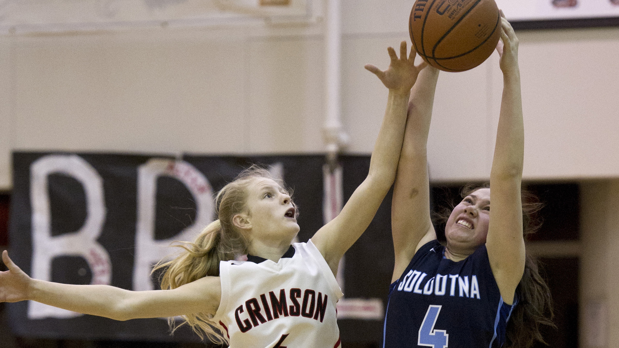 Juneau-Douglas’ Sadie Tuckwood, left, and Soldotna’s Mei Miller go for ball at JDHS on Friday. JDHS won 48-46. (Michael Penn | Juneau Empire)