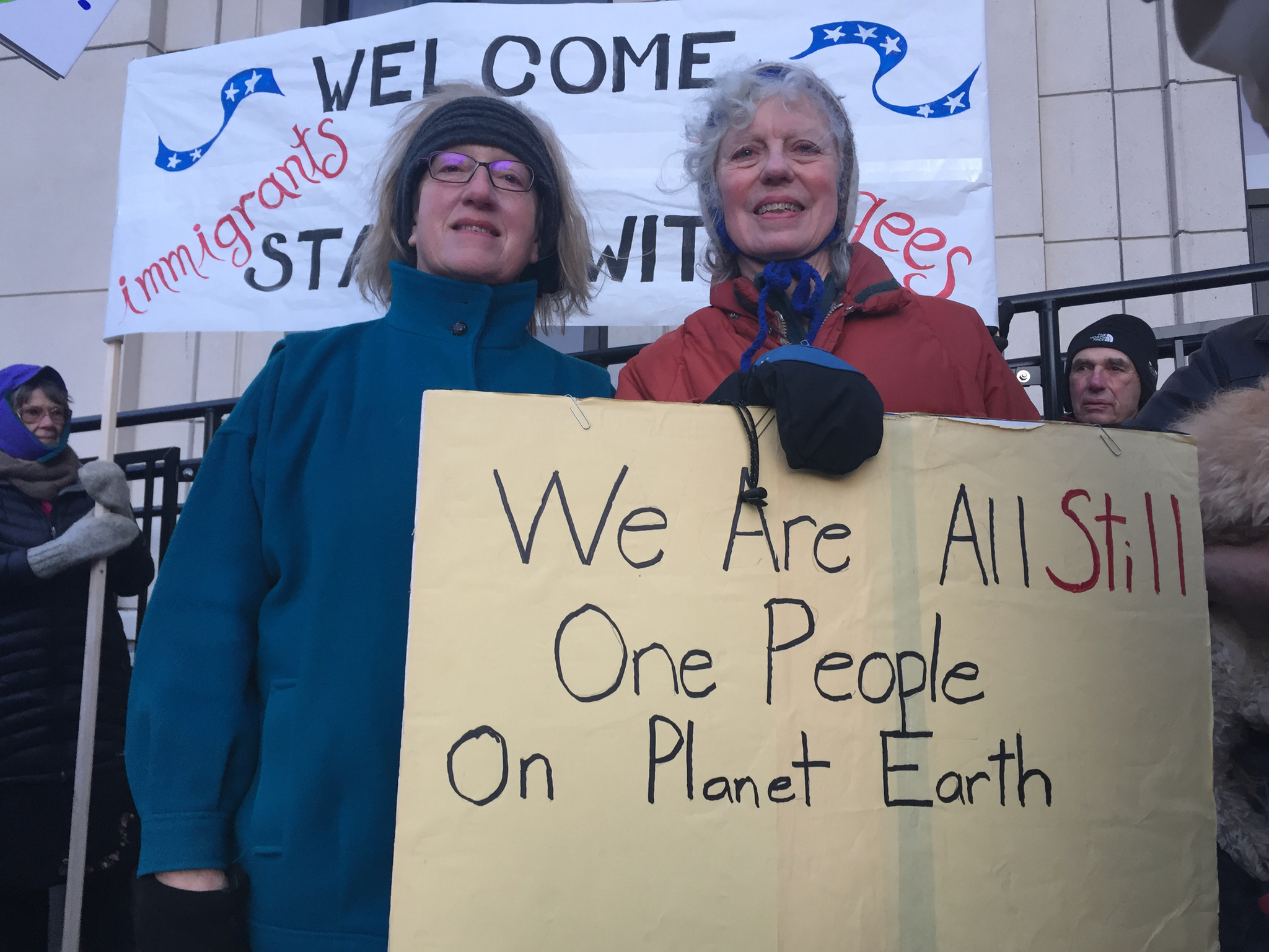 From left, Cathy Botelho and Judith Maier at the “Stand with Refugees and Immigrants” event Monday morning. This was the second gathering organized in front of the Alaska State Capitol, aimed both at showing support for refugees and immigrants and thanking Alaskan legislators who have spoken out against President Donald Trump’s executive order. (Mary Catharine Martin | Juneau Empire)