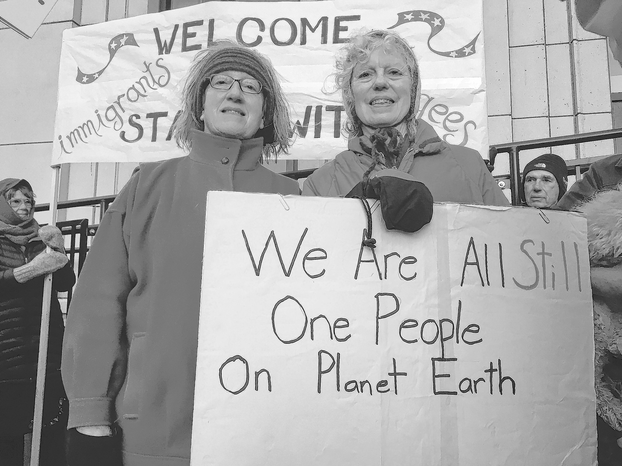 From left, Cathy Botelho and Judith Maier at the “Stand with Refugees and Immigrants” event Monday, Feb. 6. This was the second gathering organized for 7 - 8:30 a.m. Monday morning in front of the Capitol, aimed both at showing support for refugees and immigrants and thanking Alaskan legislators who have spoken out against President Donald Trump’s executive order. (Mary Catharine Martin | Capital City Weekly)
