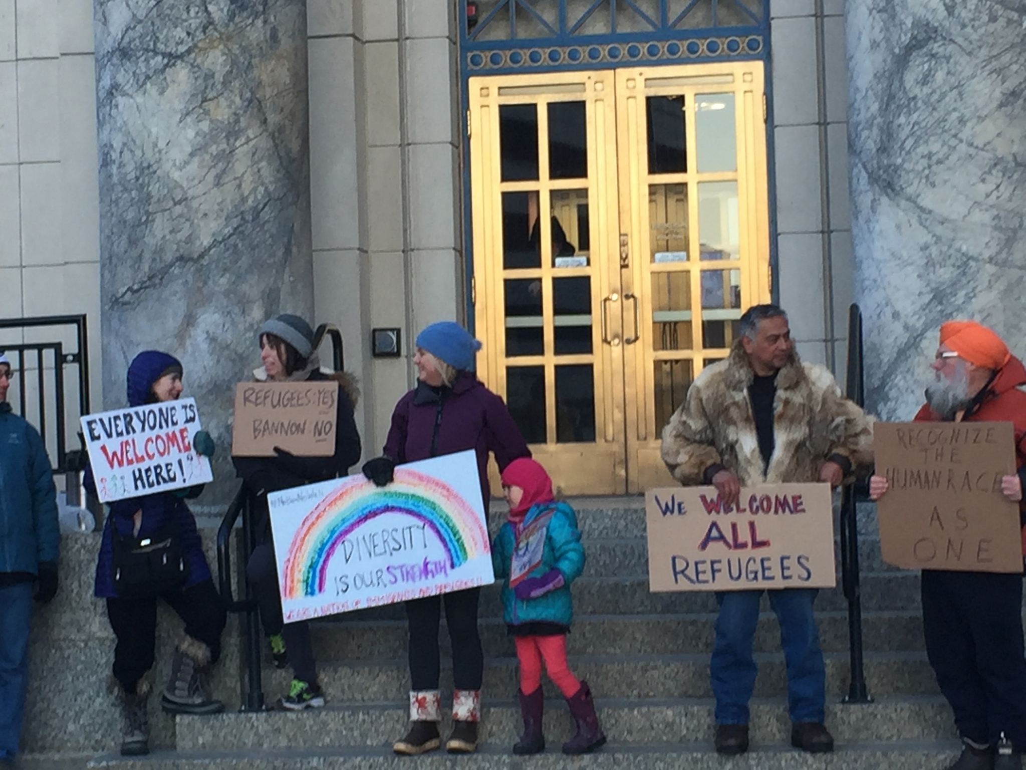 People gathered prior to work (from 7-8:30 a.m.) Monday in front of the Alaska State Capitol to support refugees and immigrants. (Mary Catharine Martin | Juneau Empire)