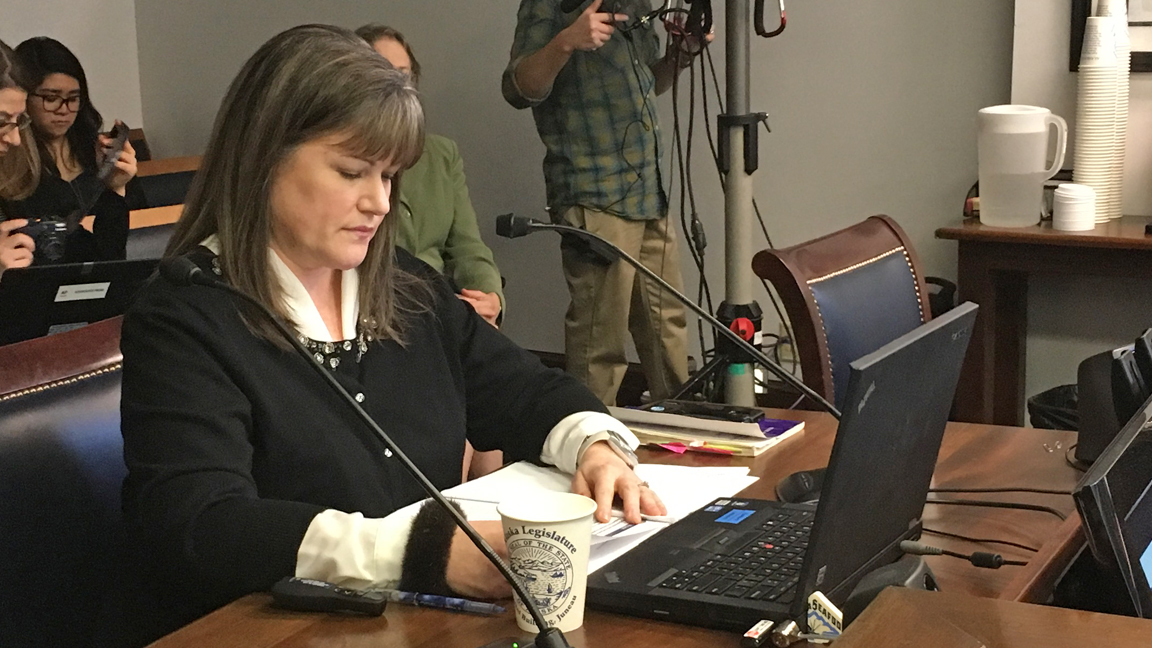 Sara Chambers, interim director of the Alcohol and Marijuana Control Office, looks over her notes during a presentation to the House Finance Committee’s subcommittee on the budget for the Alaska Department of Commerce on Tuesday in the Alaska State Capitol. (James Brooks | Juneau Empire)