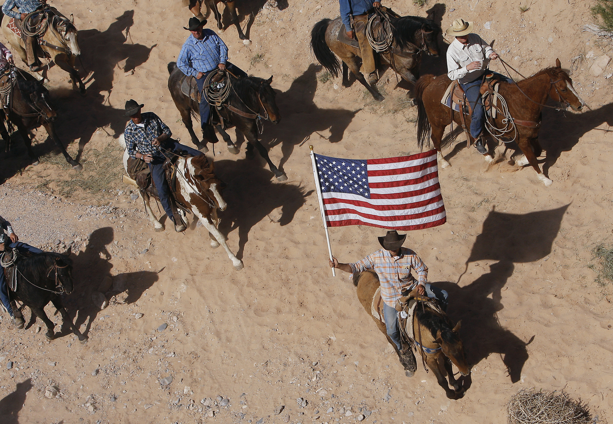 In this April 12, 2014 photo, the Bundy family and their supporters fly the American flag as their cattle is released by the Bureau of Land Management back onto public land outside of Bunkerville, Nev. A federal judge in Nevada is considering crucial rulings about what jurors will hear in the trial of six defendants accused of stopping U.S. agents at gunpoint from rounding up cattle near Cliven Bundy’s ranch in April 2014. (Jason Bean | Las Vegas Review-Journal)