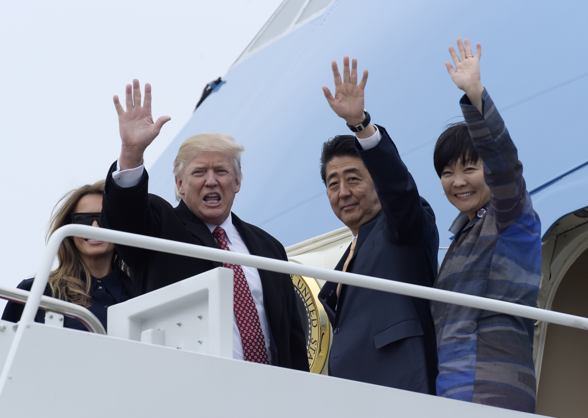 President Donald Trump and Japanese Prime Minister Shinzo Abe, accompanied by their wives, first lady Melania Trump and Akie Abe, wave before boarding Air Force One at Andrews Air Force Base Maryland on Friday, Feb. 10, 2017. Trump is hosting Abe at his estate Mar-a-Lago in Palm Beach, Florida for the weekend. (Susan Walsh | The Associated Press)