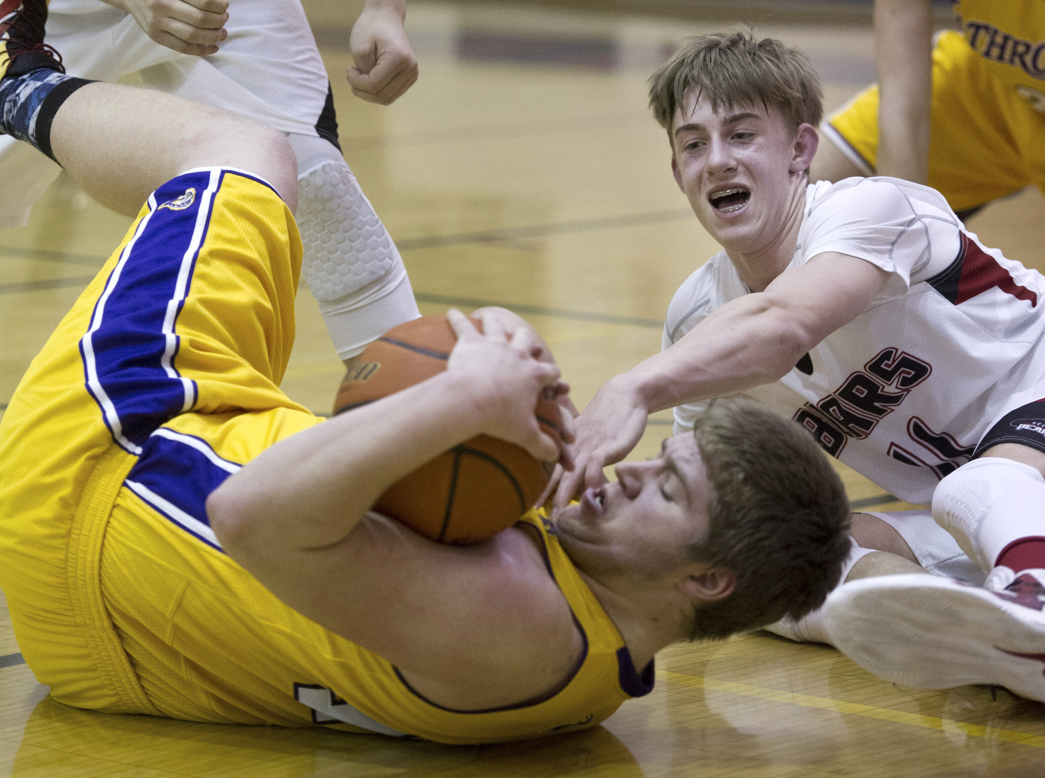 Juneau-Douglas’ Kolby Hoover, right, wrestles with Lathrop’s Jake Carlson for the ball at JDHS on Friday, Feb. 10, 2017. JDHS won 50-43. (Michael Penn | Juneau Empire)