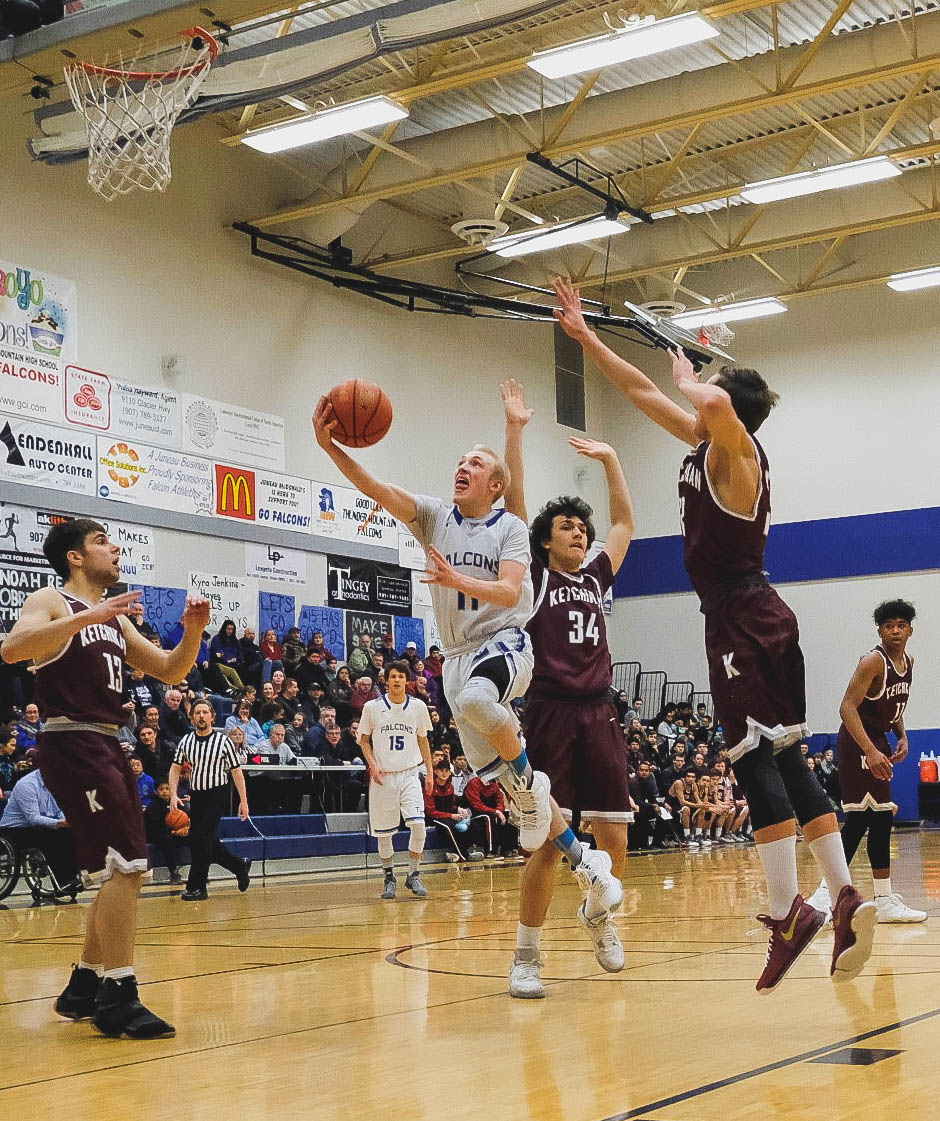 Thunder Mountain High School guard Chase Saviers slips between Ketchikan’s Brent Taylor and Robert Seludo during the Falcons’ win over the Kings on Saturday, Feb. 11 at Thunder Mountain High School. (Lance Nesbitt | For the Juneau Empire)