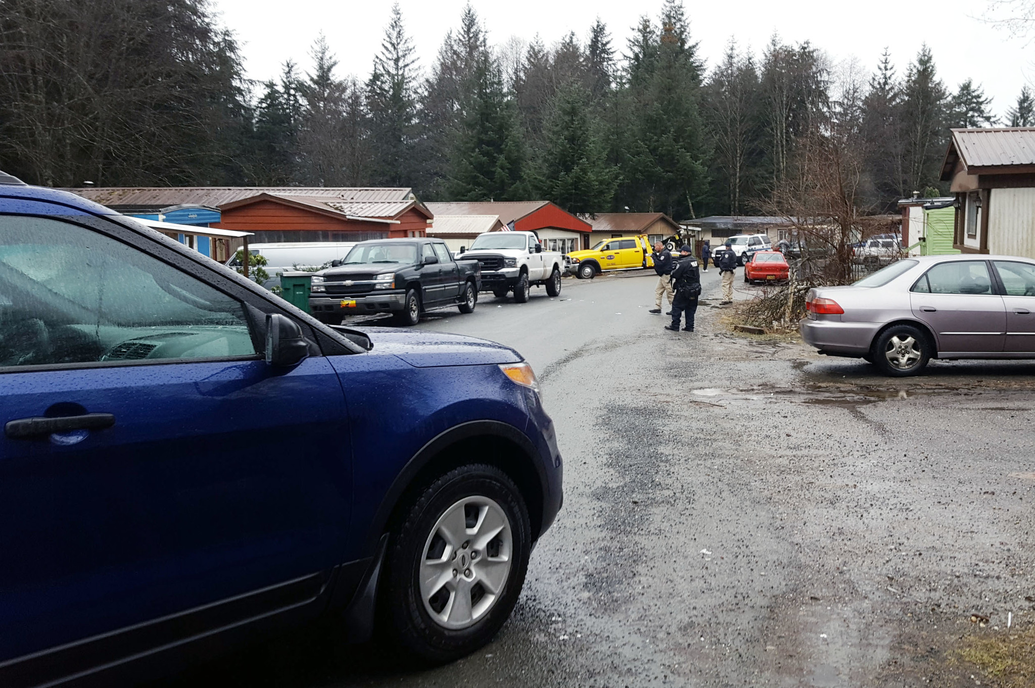 Juneau Police Department investigators at the scene of a shooting incident at Switzer Mobile Home Park Wednesday morning. (Liz Kellar | Juneau Empire)