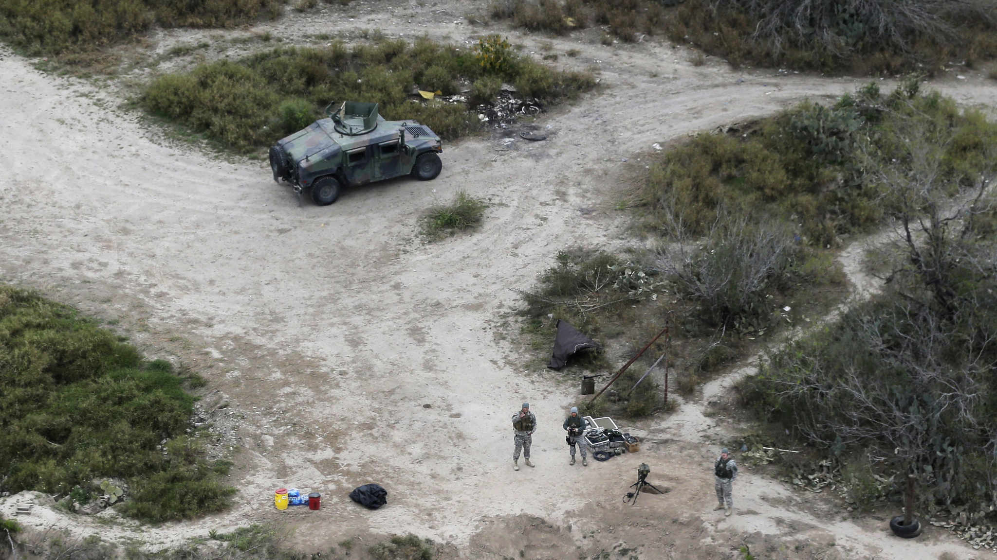 In this Feb. 24, 2015 photo, members of the National Guard patrol along the Rio Grande at the Texas-Mexico border in Rio Grande City, Texas. The Trump administration is considering a proposal to mobilize as many as 100,000 National Guard troops to round up unauthorized immigrants, including millions living nowhere near the Mexico border, according to a draft memo obtained by The Associated Press. (Eric Gay | The Associated Press file)