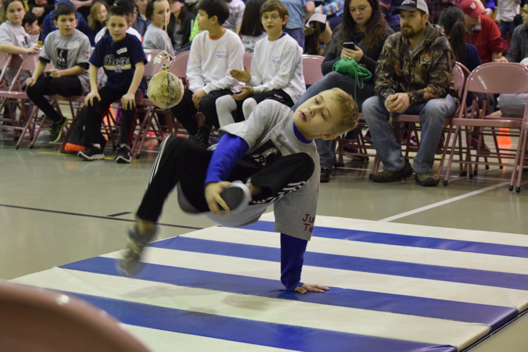 An Auke Bay Elementary School student competes in the 1-foot high kick as part of the Native Youth Olympics Friday at Riverbend Elementary. (Nolin Ainsworth | Juneau Empire)