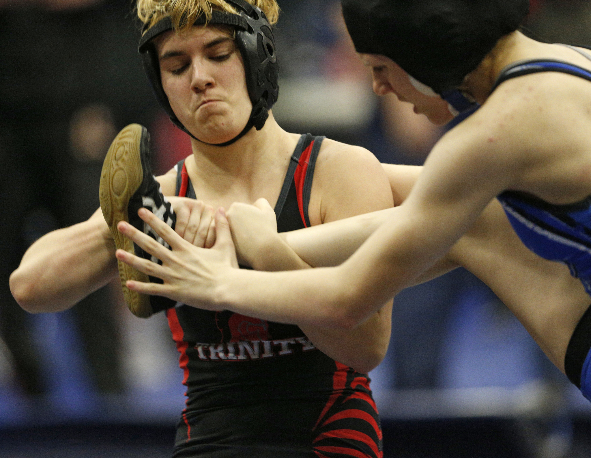 In this Feb. 18 photo, Euless Trinity’s Mack Beggs, left, wrestles Grand Prairie’s Kailyn Clay during the finals of the UIL Region 2-6A wrestling tournament at Allen High School in Allen, Texas. Beggs, who is transgender, is transitioning from female to male, won the girls regional championship after a female opponent forfeited the match. (Nathan Hunsinger | The Dallas Morning News)