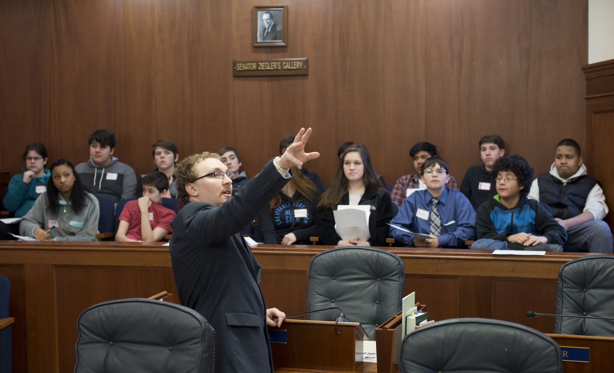 Senate Page Jacob Pennell gives eighth-graders from Floyd Dryden Middle School details about how the Senate works during a tour of the Capitol on Thursday. Juneau School District eighth-graders spend a day at the Capitol combined with a trip to the Dimond Courthouse to learn and see how their government works. The program is done by volunteers according to coordinator Marjorie Menzi. (Michael Penn | Juneau Empire)
