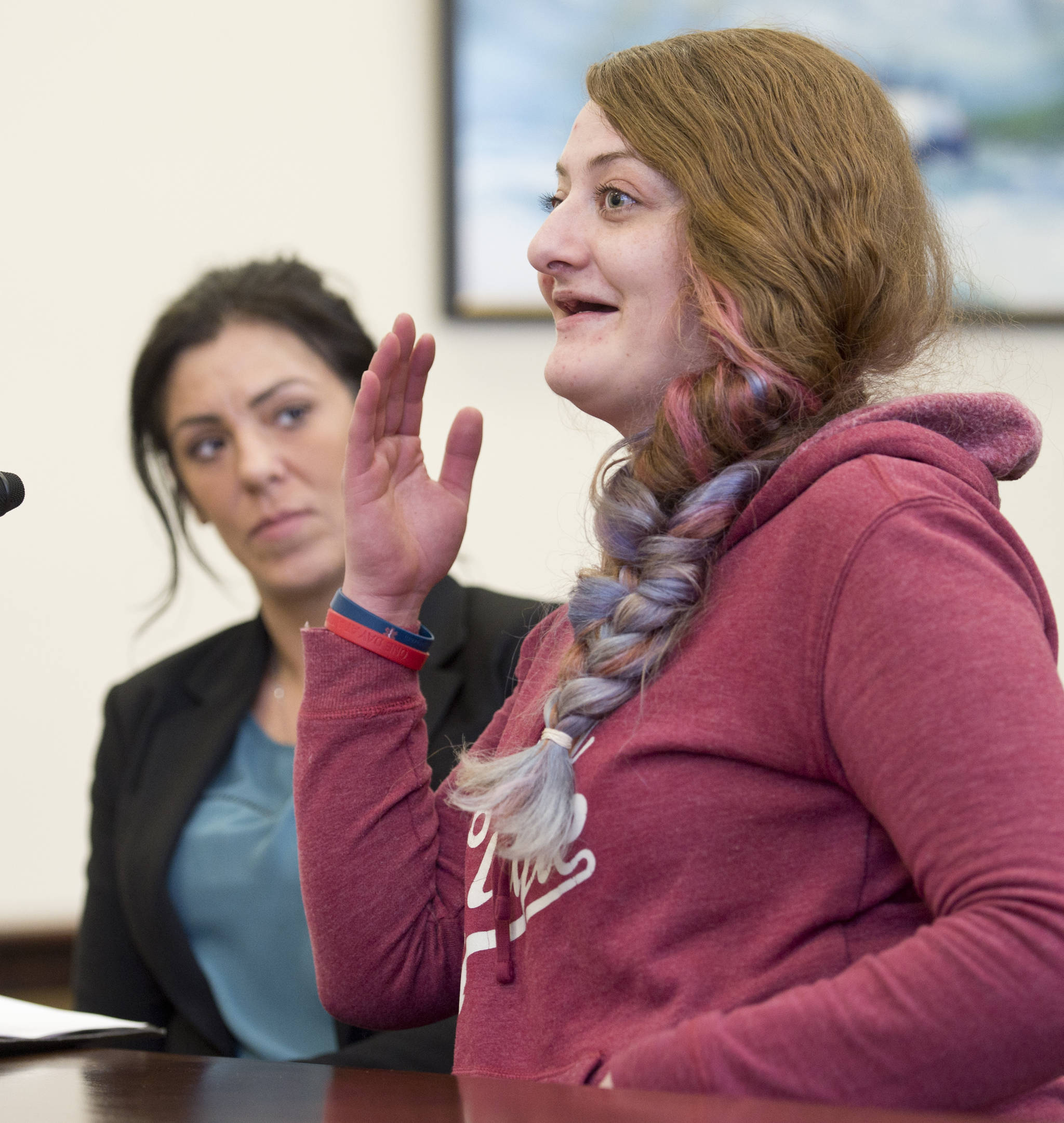 Mia Berzanske, right, speaks to the Senate Judiciary Committee with Kara Nelson, executive director of Haven House, against SB 54 on crime and sentencing at the Capitol on Friday. Berzanske is currently a resident of Haven House, a halfway house for women coming out of prison. (Michael Penn | Juneau Empire)