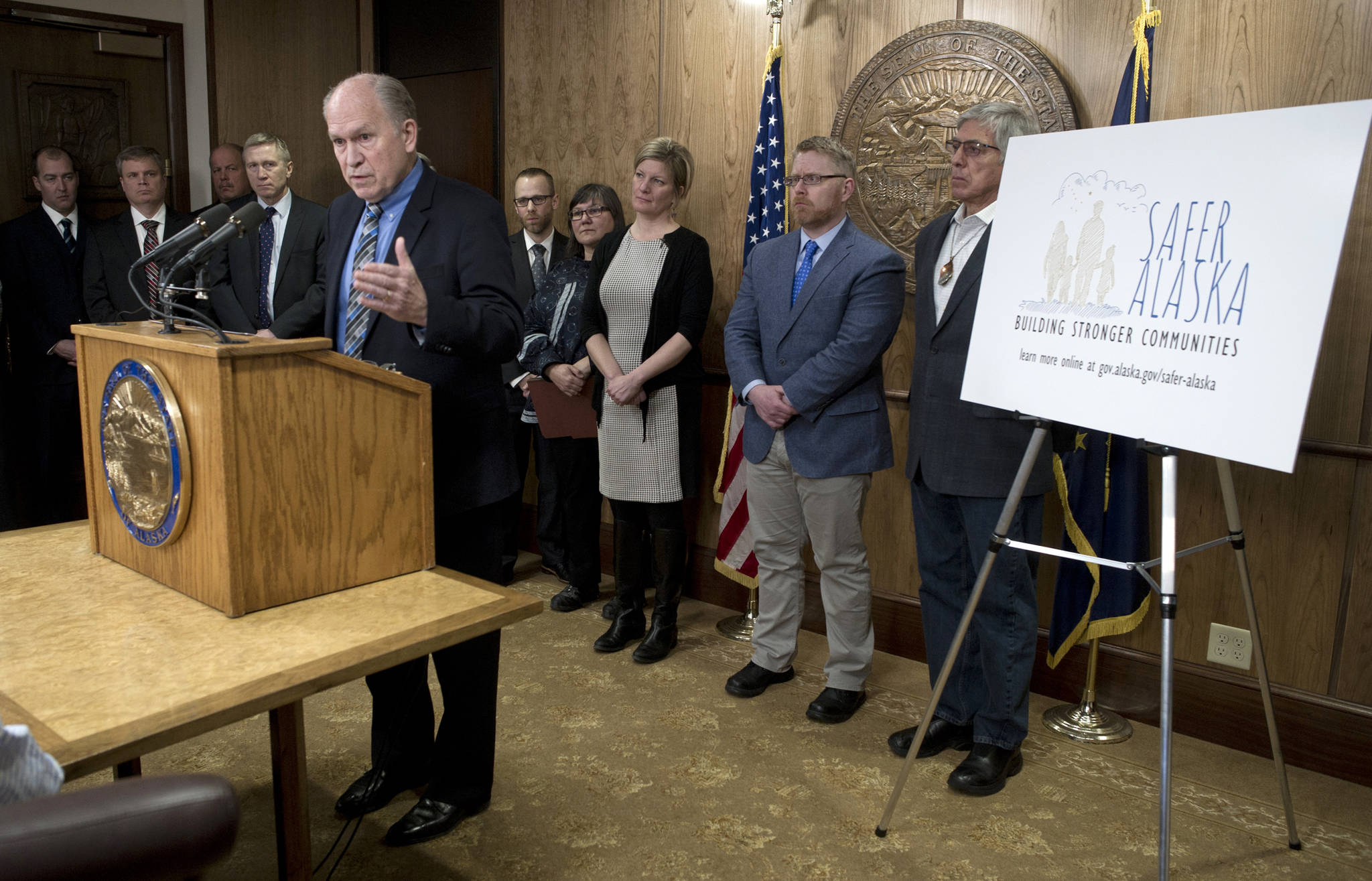Surrounded by his Cabinet and staff members, Gov. Bill Walker speaks at a Capitol press conference on Monday about legislation he is introducing to change the way opioids are prescribed and monitored. (Michael Penn | Juneau Empire)