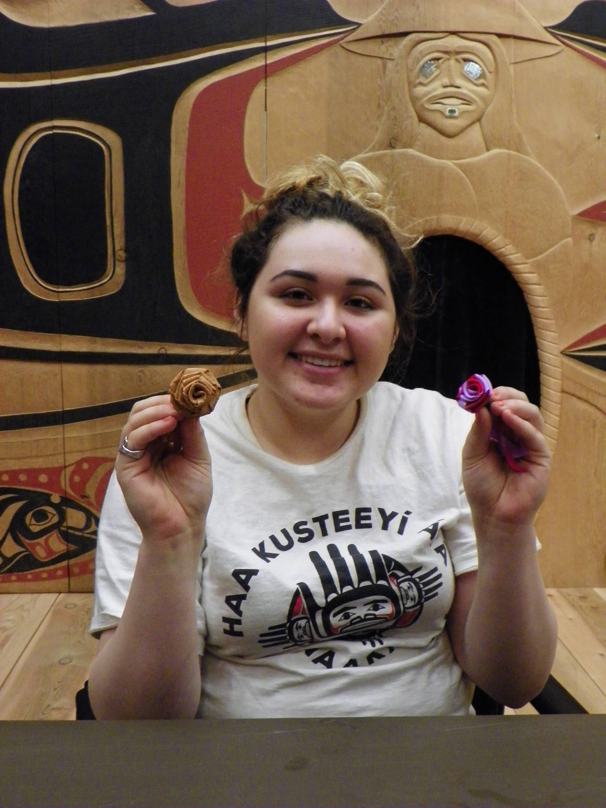 A student poses with a creation from her time in Culture Camp. Photo by Mary Beth Moss.