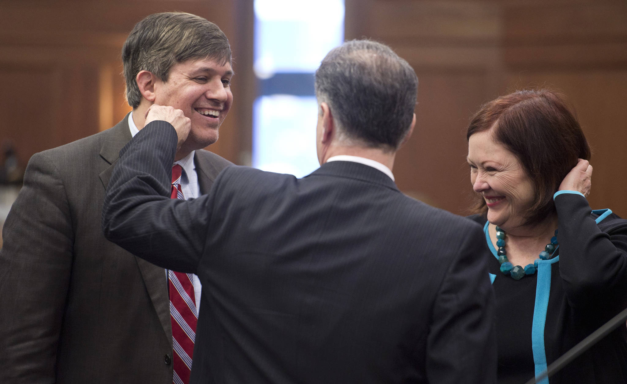 Sen. Bill Wielechowski, D-Anchorage, left, receives a lighthearted punch by Senate Majority Leader Pete Micciche, R-Soldotna, as Senate Minority Leader Berta Gardner, D-Anchorage, watches after Wielechowski’s three amendments to SB 26 were voted down in the Senate chambers on Wednesday. The Senate voted to use a portion of earnings from the Alaska Permanent Fund to fund government and cap dividends at $1,000 per person. (Michael Penn | Juneau Empire)