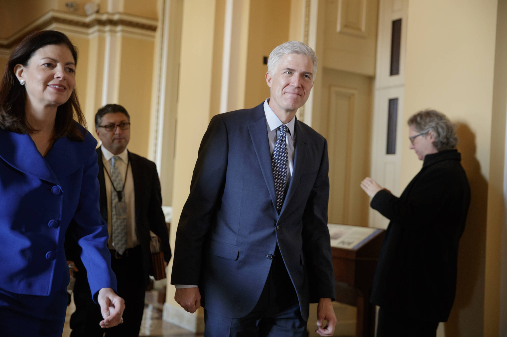 In this Feb. 2 photo, Supreme Court Justice nominee Neil Gorsuch, right, escorted by former New Hampshire Sen. Kelly Ayotte walks on Capitol Hill in Washington. (J. Scott Applewhite | The Associated Press)