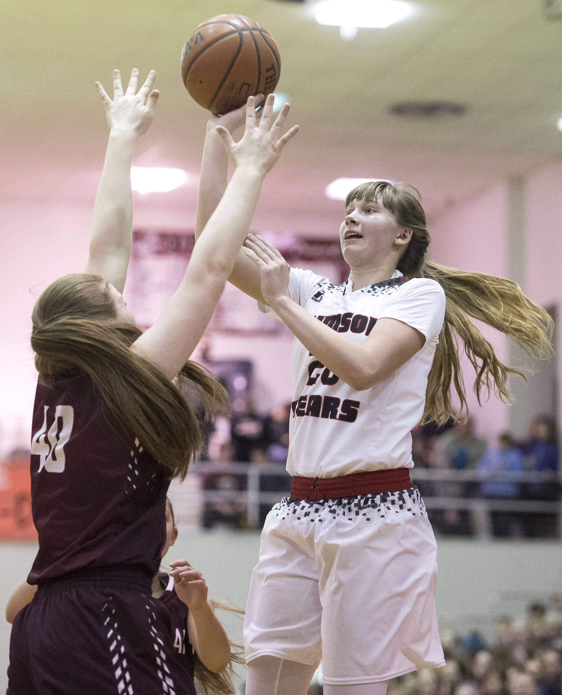 Juneau-Douglas&rsquo; Caitlin Pusich shoots against Ketchikan&rsquo;s Sarah McClennan during the Region V Basketball finals at JDHS on March 10. (Michael Penn | Juneau Empire)