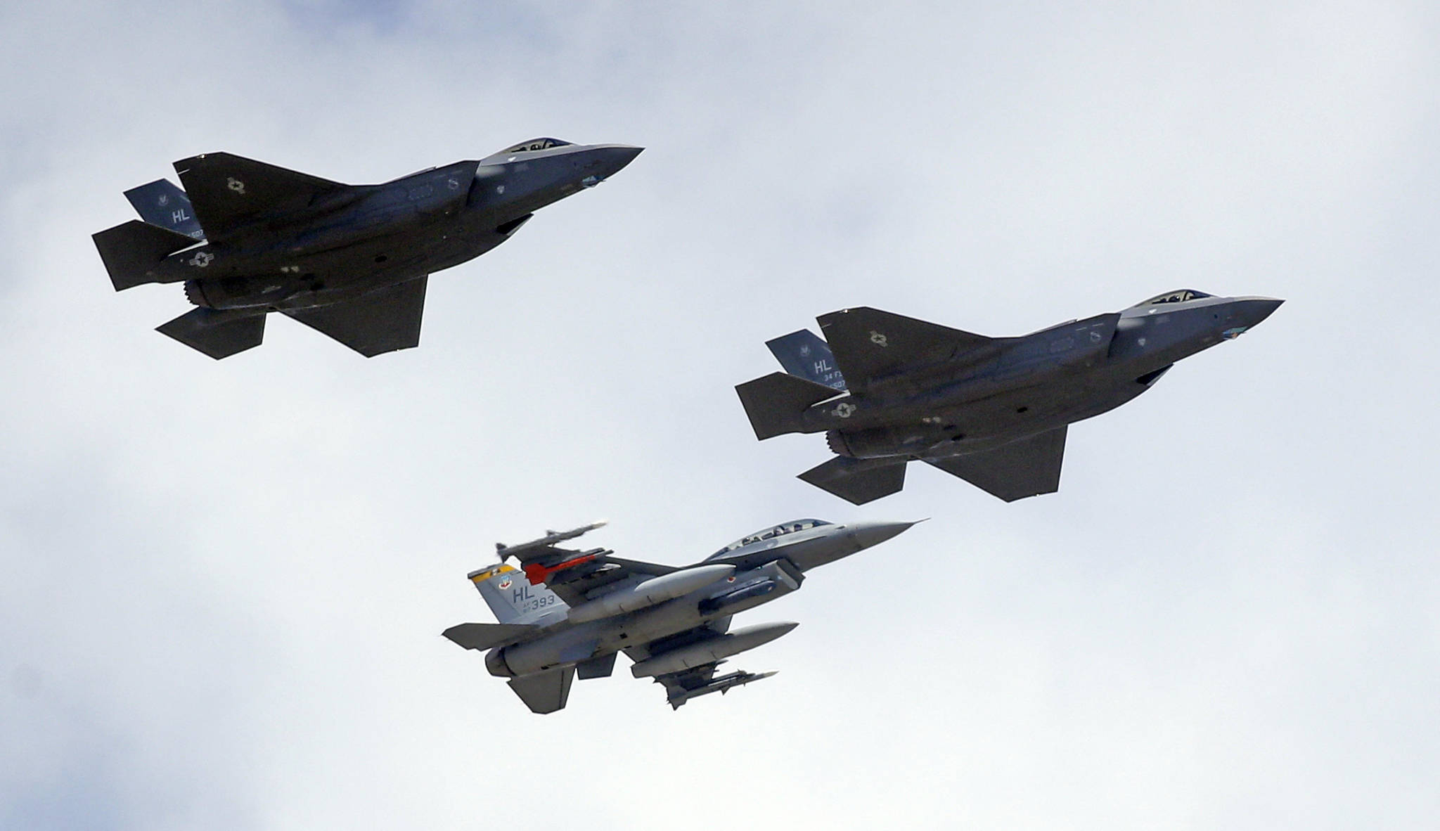 This Sept. 2, 2015 photo shows an F-16, below, escorting two F-35 jets, above, after arriving the latter arrived at Hill Air Force Base in Utah. The U.S. and its Asia-Pacific allies are rolling out their new stealth fighter jet, a cutting-edge plane that costs about $100 million each. (Rick Bowmer | The Associated Press File)